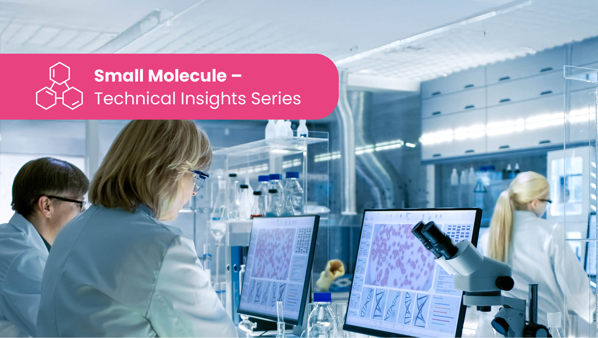 Scientists in a modern biomedical laboratory using microscopes and computer stations