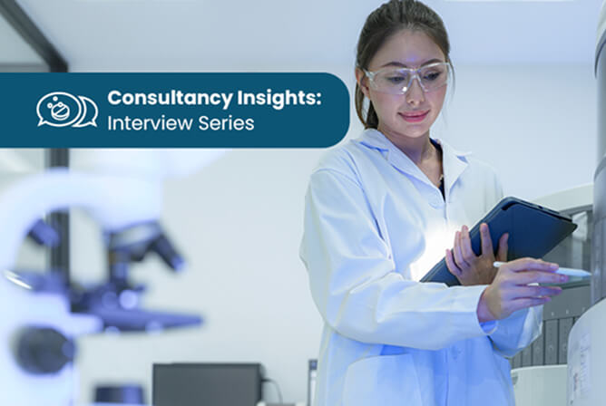Scientists in a modern biomedical laboratory using microscopes and computer stations